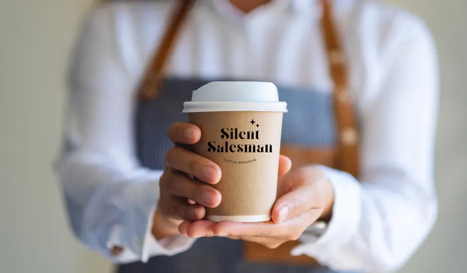 Person holding Silent Salesman cup